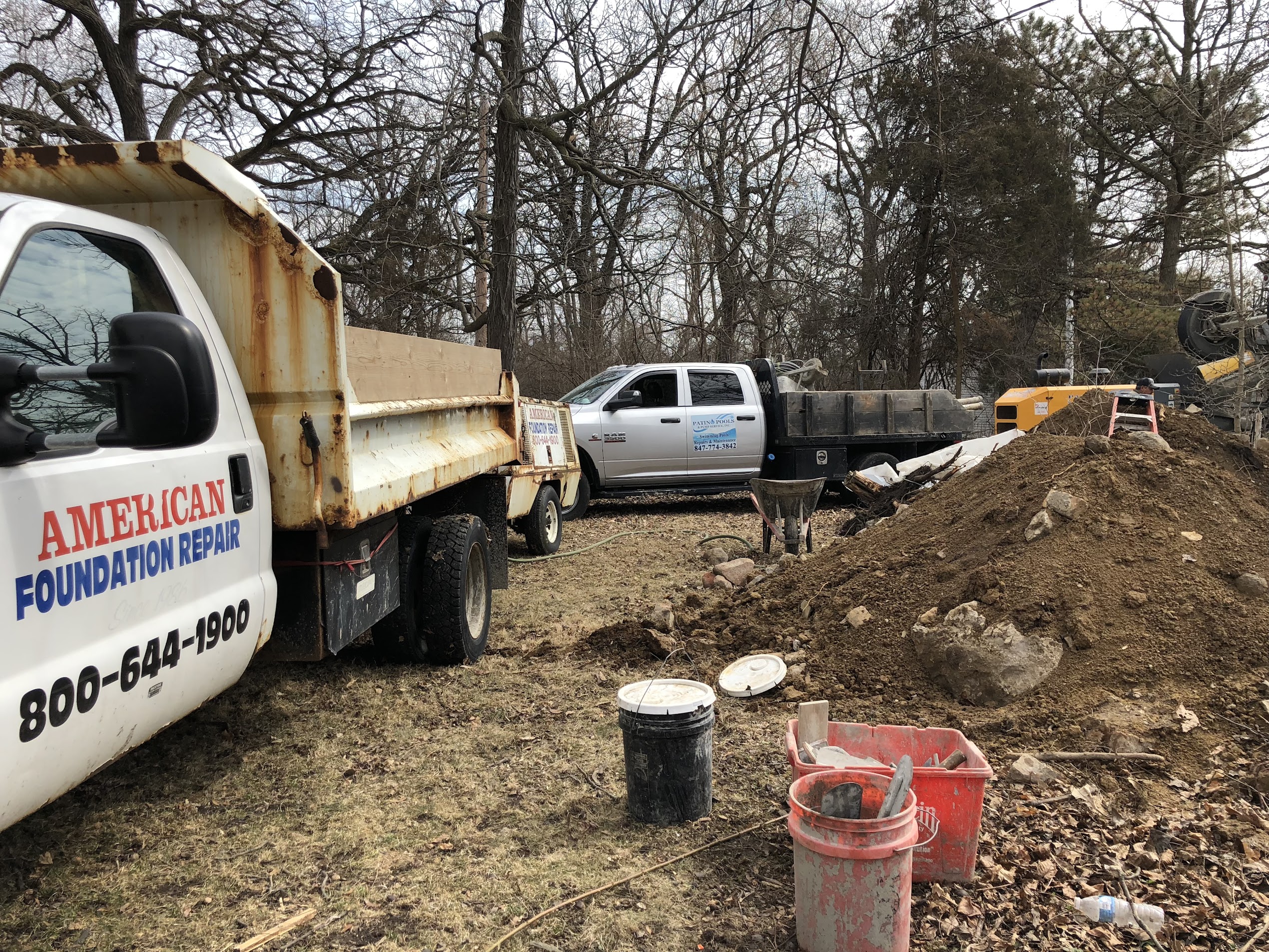 Foundation repair work area beside a residential home